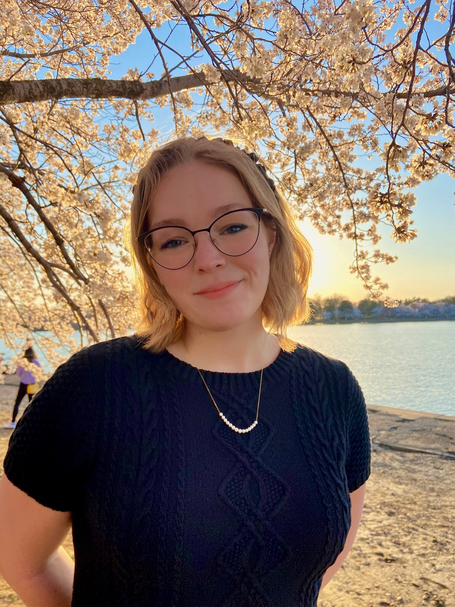 Emilie Austin in front of cherry blossoms